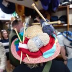 Visitor in knit hat to T Snook hat shop in Dorset UK during Bridport Hat Festival 2023