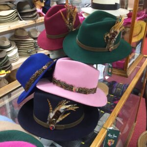 Wool felt hats with two types of feather trim at T Snook, hat shop in Bridport, Dorset