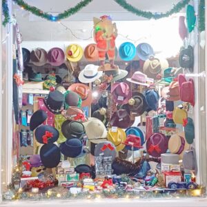 December 2023 window display at T Snook (No 32), hat shop in Bridport, Dorset, UK