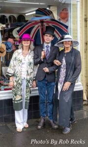 Elegant Ensemble competition of Bridport Hat Festival 2024 - gents winner with Linda and Sue outside Snooks