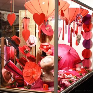February 2025 window (side view) with Valentine's theme at T Snook, hat shop in Bridport, Dorset, England