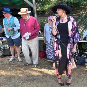 Bridport Hat Festival 2025 'Elegant Ensemble' competition, sponsored by T Snook, hatters. The judges and compère Sue.