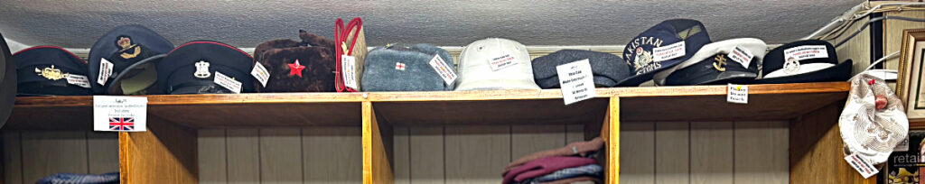 Uniform caps & hats - part of the 'mini hat museum' at T Snook, hatters of Bridport, Dorset, UK