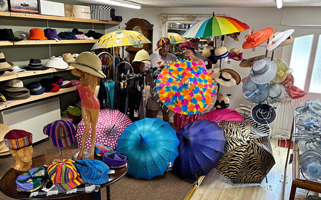 Colourful cotton caps and various-material smoking caps, and umbrellas/parasols - at T Snook, hatters of Bridport, Dorset, UK