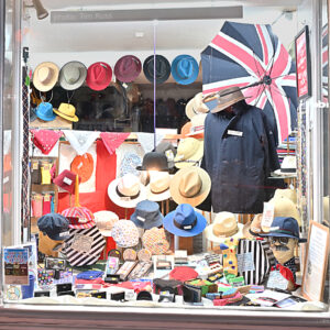 Entrance-side display window, Aug 26, at T Snook, hatters of Bridport, Dorset, UK