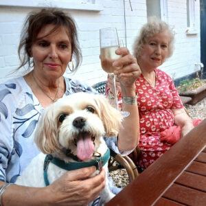 Shop dog Tuppence (with staff & owner), of T Snook, hatters of Bridport, Dorset, UK